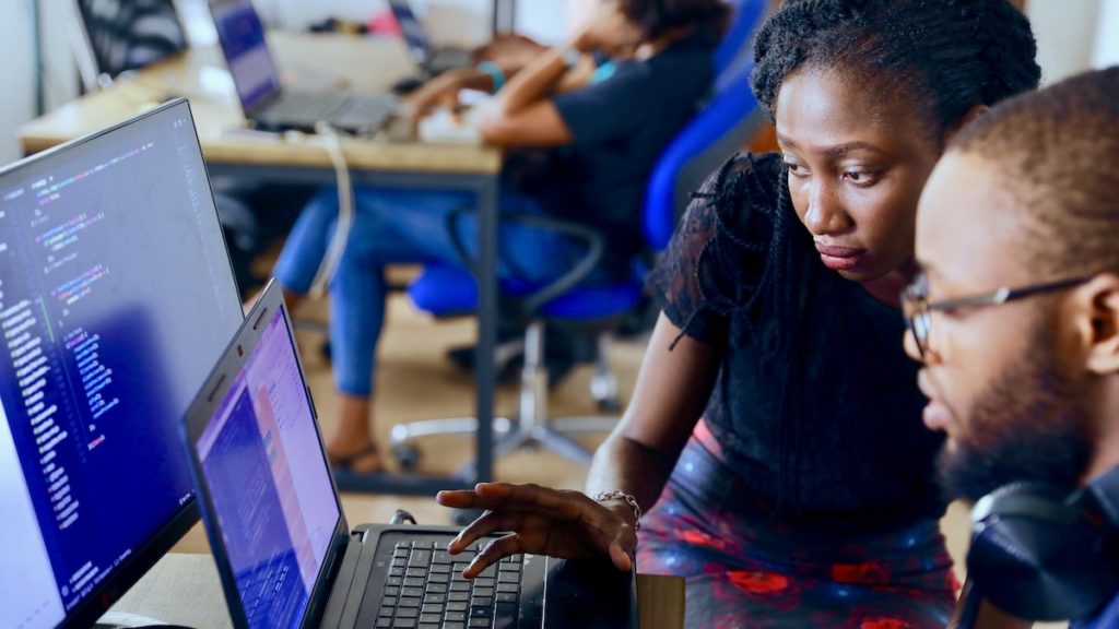 digital entrepreneurs look at a computer screen