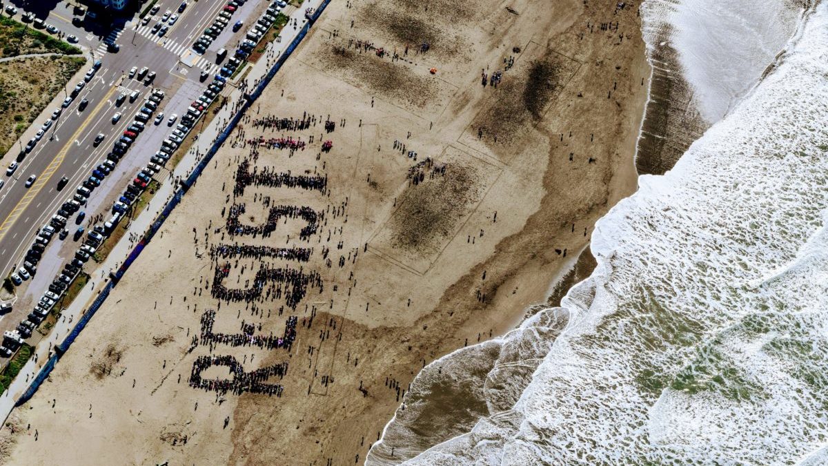 Resist written in the sand on a beach