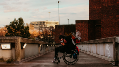 Person in wheelchair taking photos outside