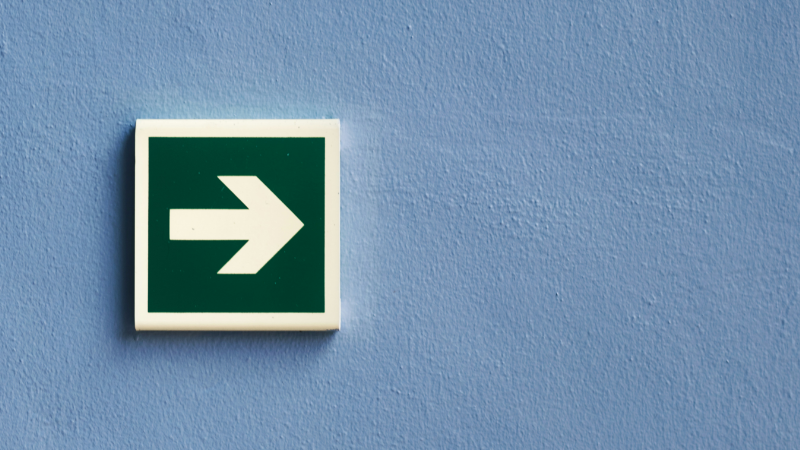 The photo shows an arrow sign on a brick wall, symbolising the DSA in terms of navigating platform power.