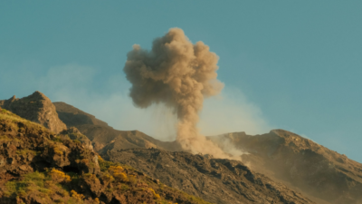 A volcanic eruption resembling an explosion, used to illustrate the metaphor of AI as a destructive "killing machine".