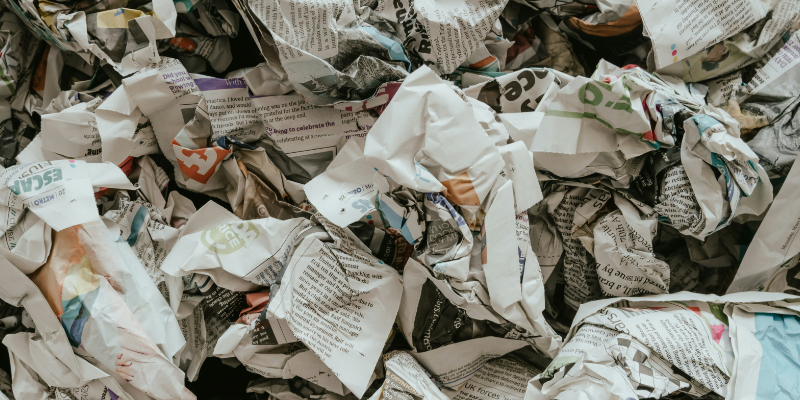a pile of crumpled up newspapers symbolising the spread of disinformation online