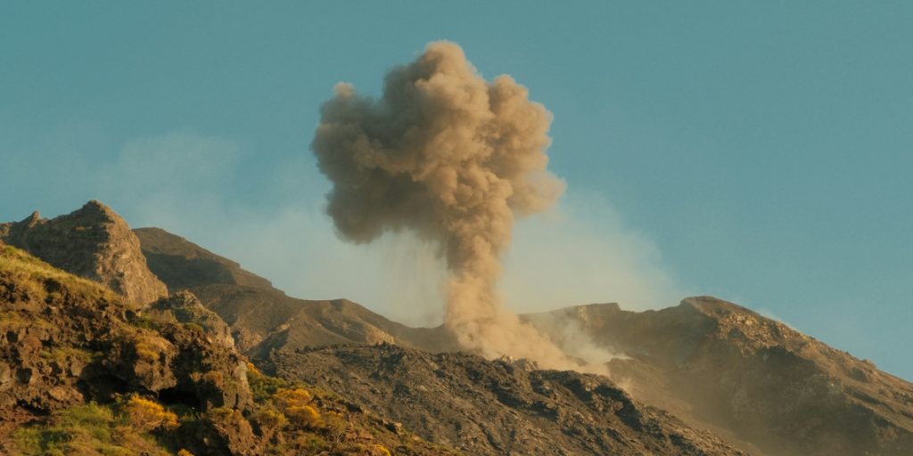 A volcanic eruption resembling an explosion, used to illustrate the metaphor of AI as a destructive "killing machine".