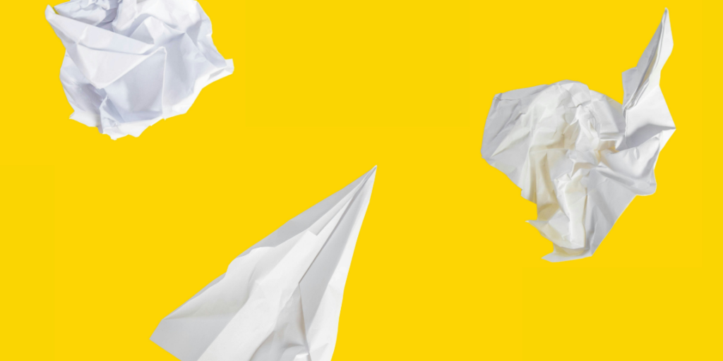 Blank white paper on a yellow background symbolising how AI emails can lack personal touch and emotion.