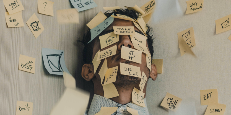 Work stress Man with a lot of post its on his face