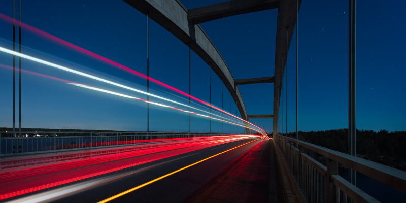 Titelbild Blogpost: Digitalisierung im Mittelstand. Eine Brücke bei Nacht mit Lichtstreifen