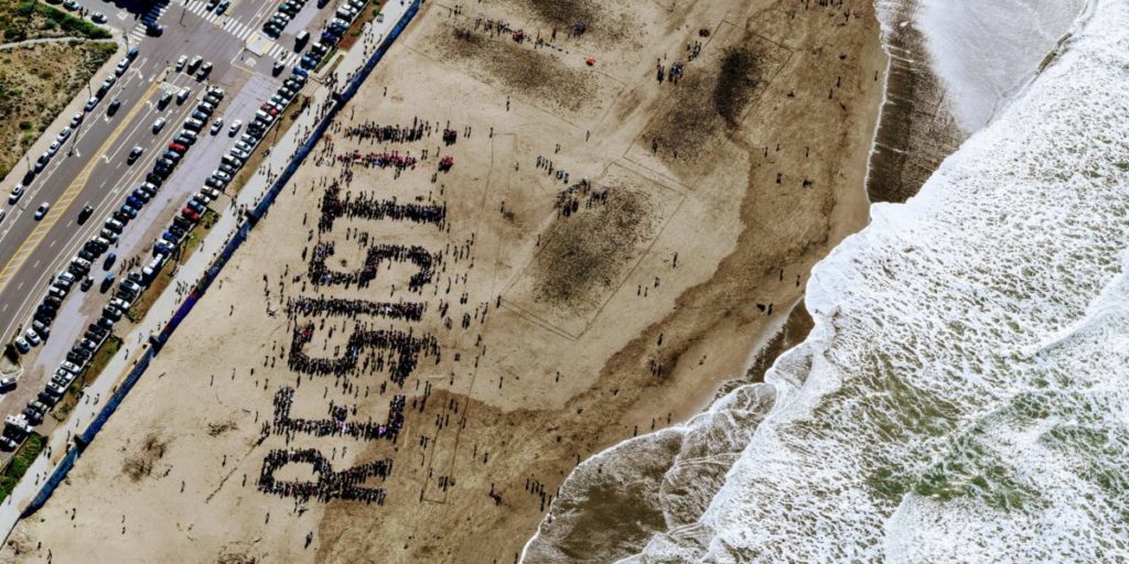 Resist written in the sand on a beach
